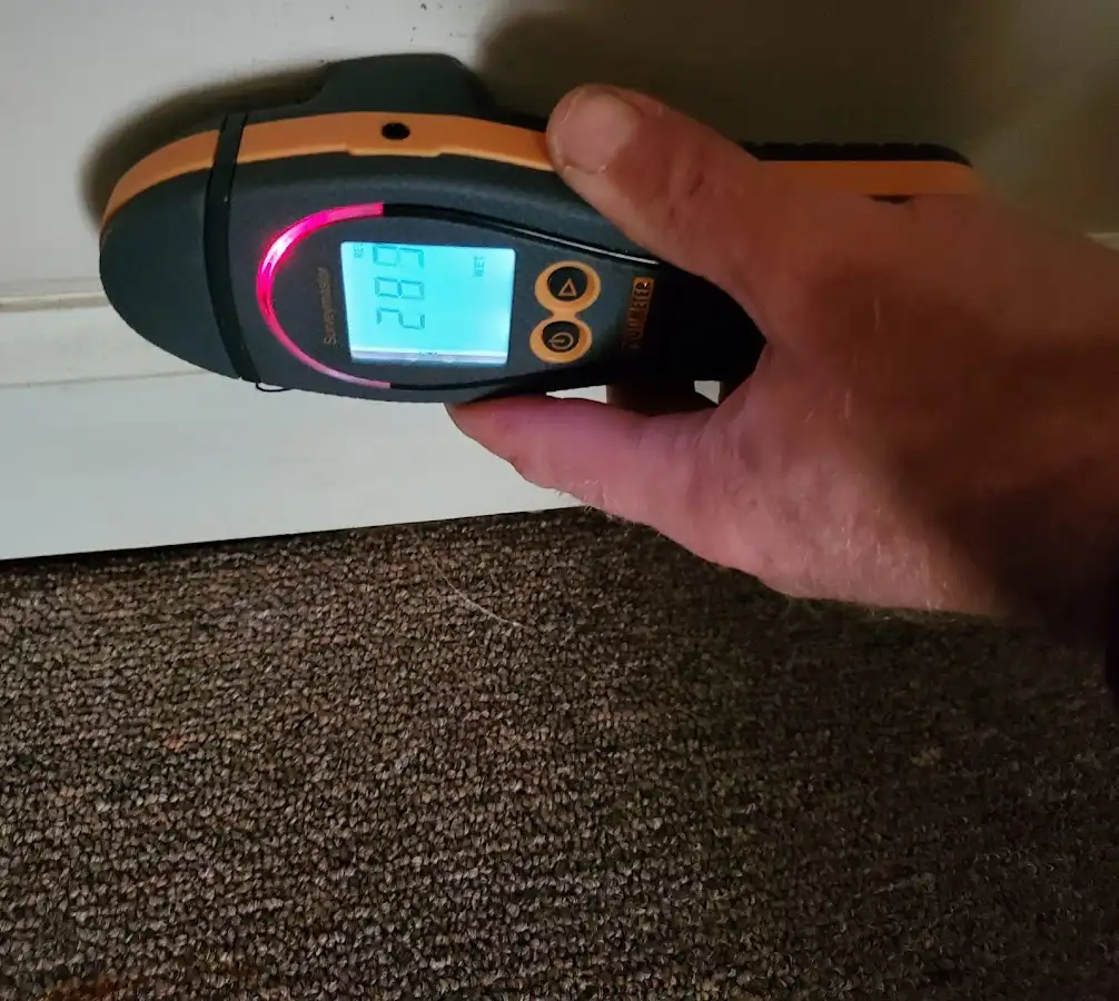 Moisture detection at baseboard during Storm Damage Restoration in Mount Hope